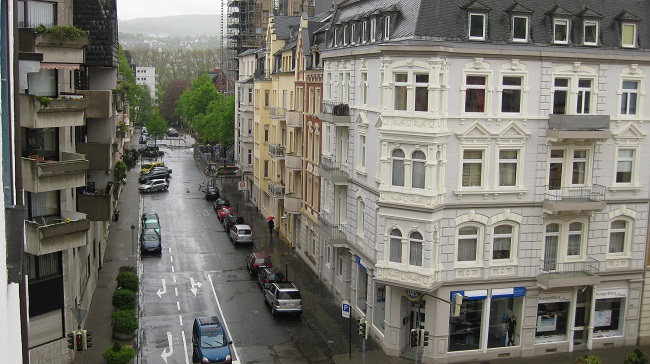A rainy street, scene from a third-storey window